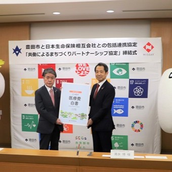 写真説明： 協定書を持つ日本生命の清水会長・松村支社長と太田市長